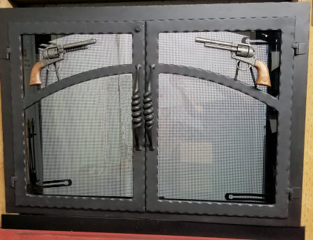 Wyatt Earp fireplace doors All black finish, hammered steel twin doors with toy pistols, heavy spiral handles, standard smoked glass Shown with gate mesh spark screens.